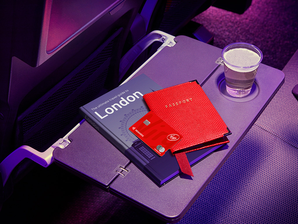 Credit card shown on economy seat tray